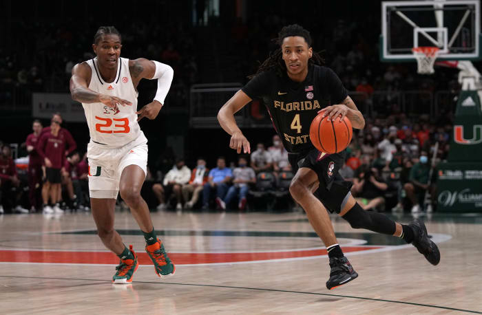 #4 Caleb Mills drives by #23 Kam McGusty of Miami. Mills is a dark horse pick for ACC Player of the Year
